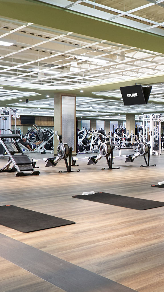 The vast workout floor area with strength machines and yoga mats at a life time location