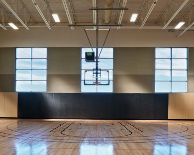 Gleaming, well-lit basketball court and gymnasium