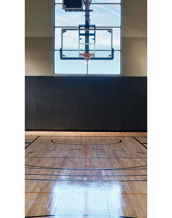 Gleaming, well-lit basketball court and gymnasium