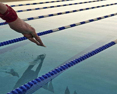 A man dives into a lap pool