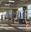 An Alpha training area with squat racks and stationary bikes