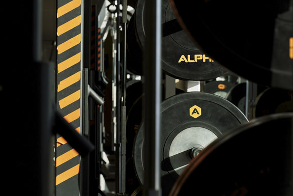 A close up of the weights on an Alpha squat rack