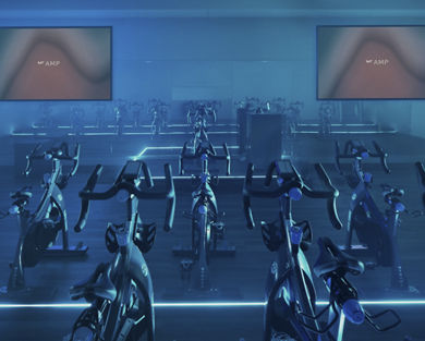 Cycle studio lit with blue lights located at the Life Time Frisco club locaton