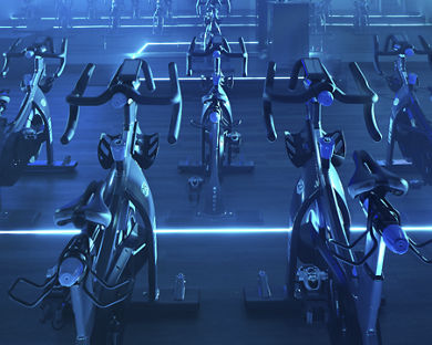 Cycle studio lit with blue lights located at the Life Time Frisco club locaton