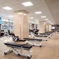 Fitness floor filled with benches and free weights at Life Time