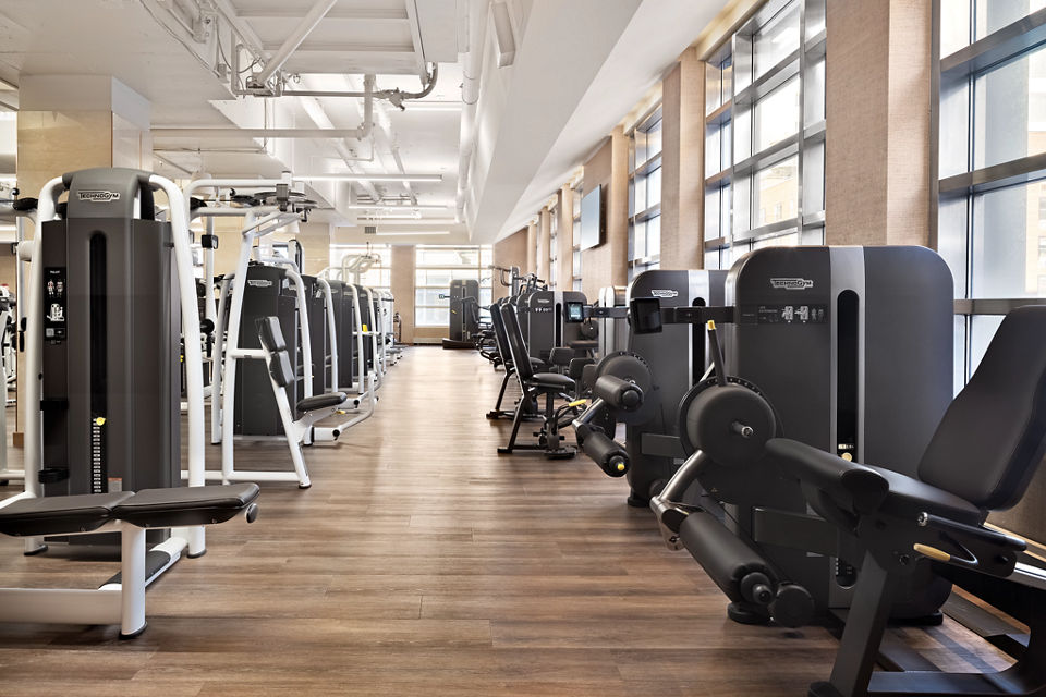 rows of weight lifting machines on a fitness floor