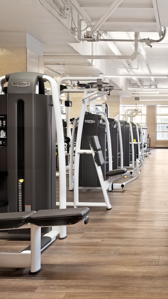 rows of weight lifting machines on a fitness floor