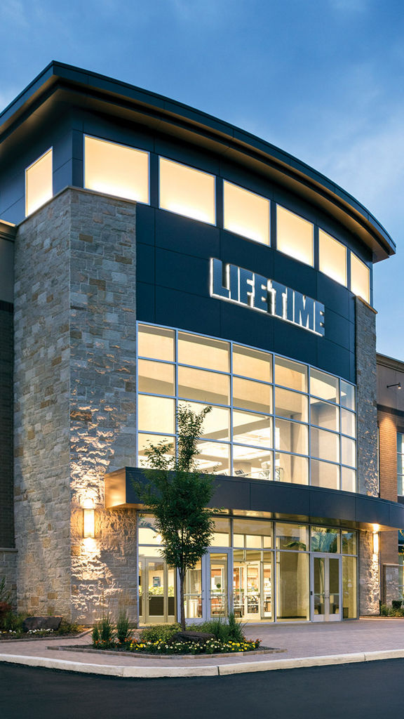 The exterior of a Life Time location at dusk