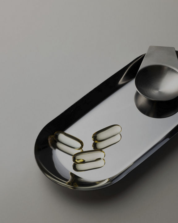 clear pill capsules in a metal tray