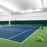 Indoor tennis courts, with a basket of tennis balls, at a Life Time location