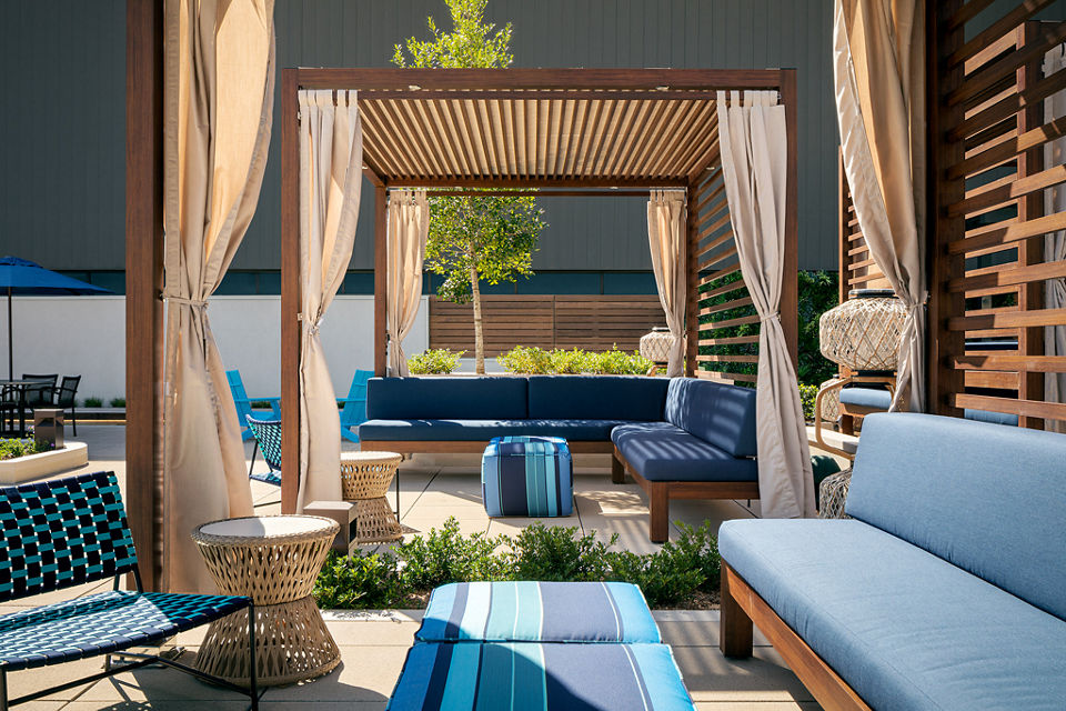 Outdoor poolside cabana's lit with bright sunlight