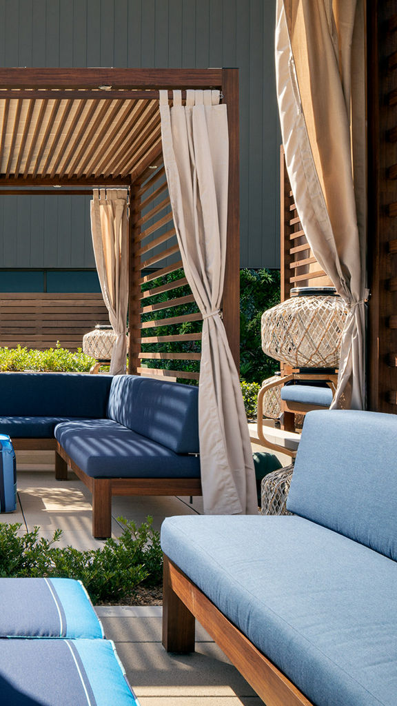 Outdoor poolside cabana's lit with bright sunlight