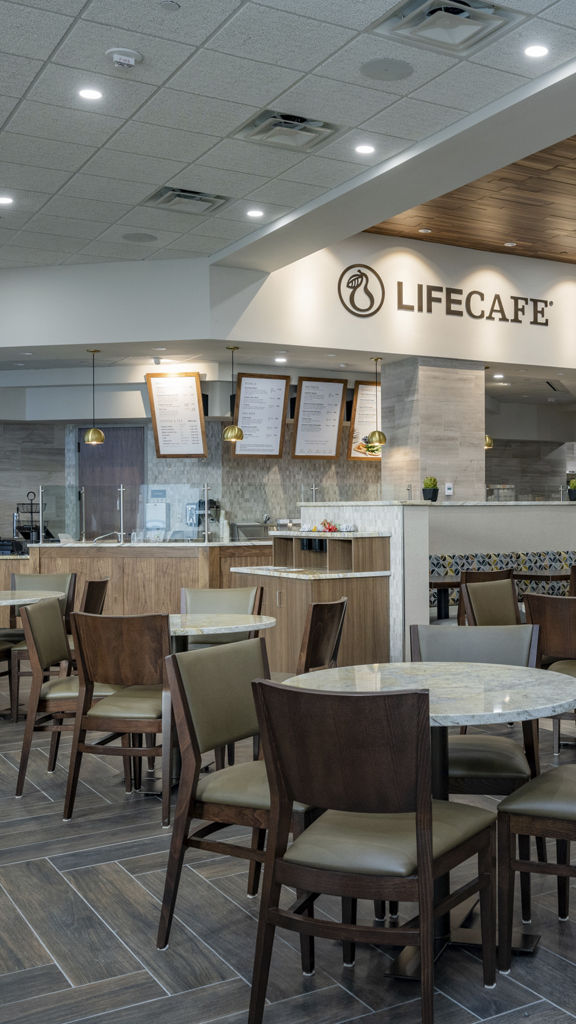 Chairs, tables, and a counter for ordering at a Life Cafe