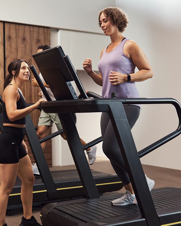 GTX instructor encouraging class member on treadmill