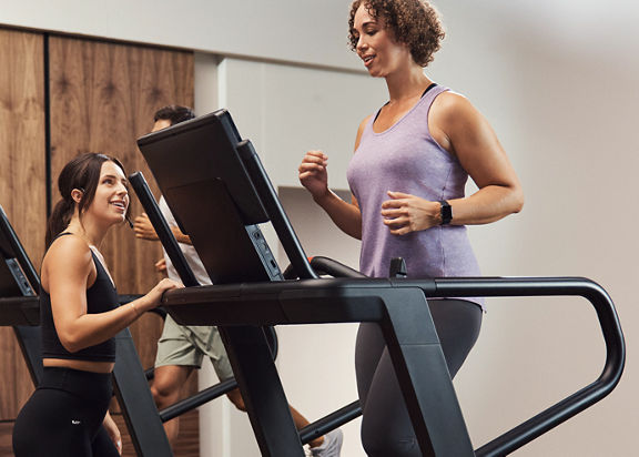 GTX instructor encouraging class member on treadmill