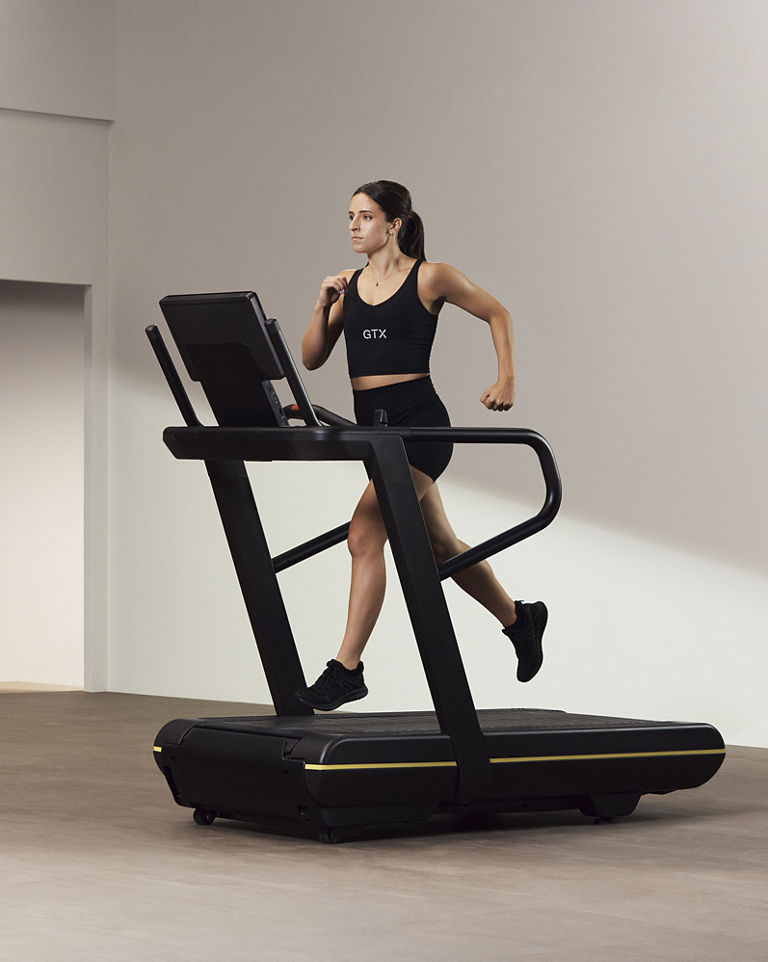 An instructor running on an elliptical