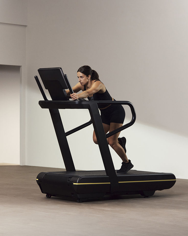 A Life Time GTX instructor demonstrating a sled push on a treadmill