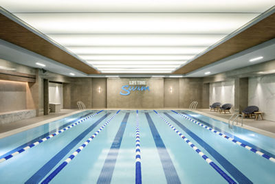 Indoor swimming pool featuring a blue ceiling, creating a serene and inviting atmosphere for swimmers.