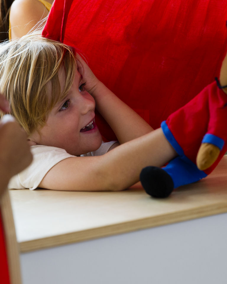 A male child playing with a puppet at Life Time Kids Academy