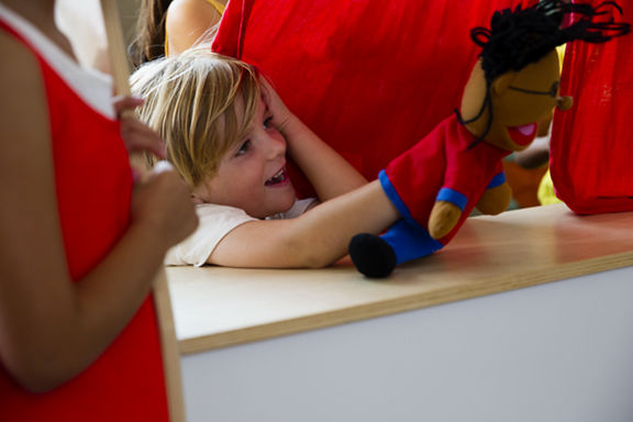 A male child playing with a puppet at Life Time Kids Academy