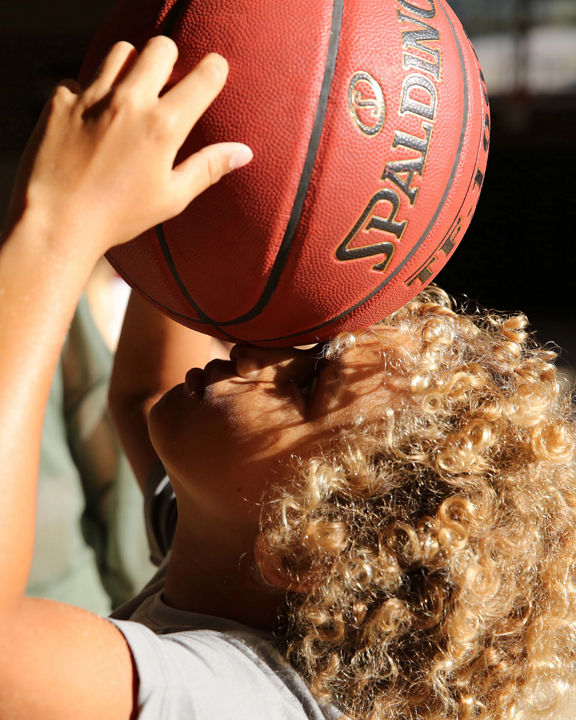 a child holding a basketball