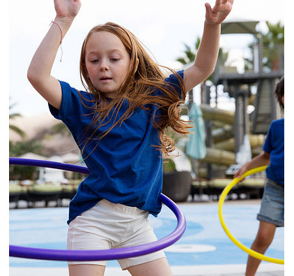 two girls playing with hula hoops