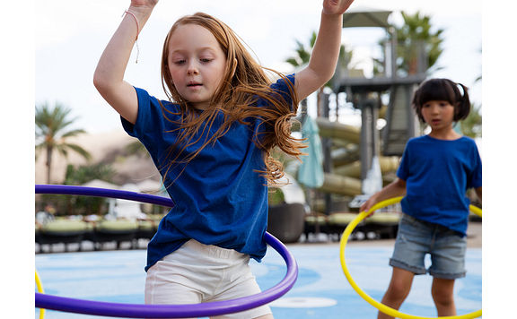 two girls playing with hula hoops