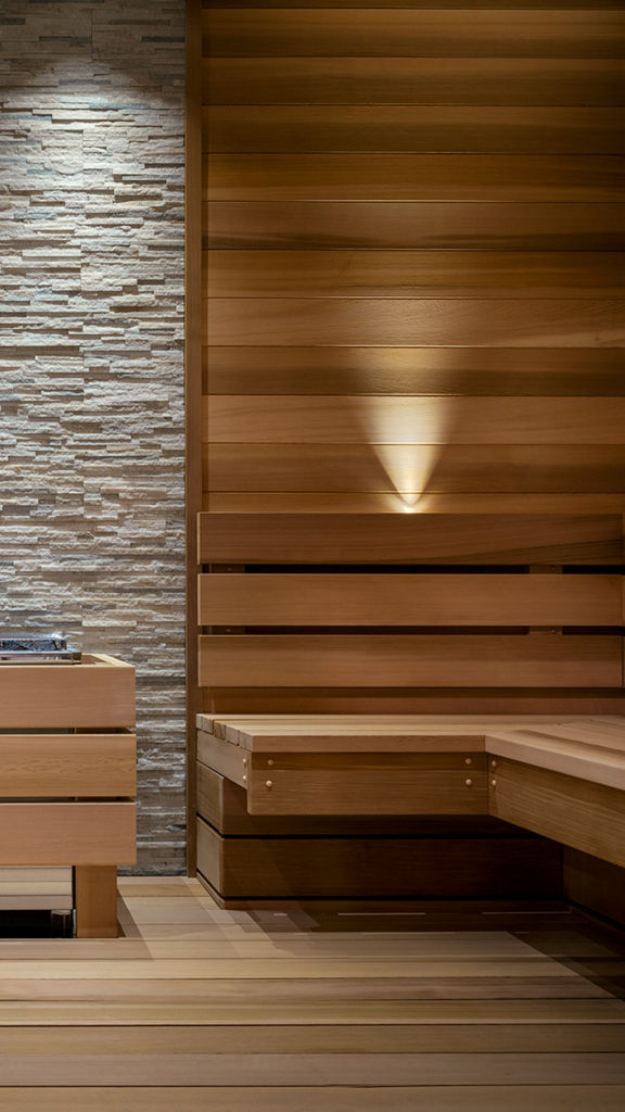 A warm wood and stone sauna interior