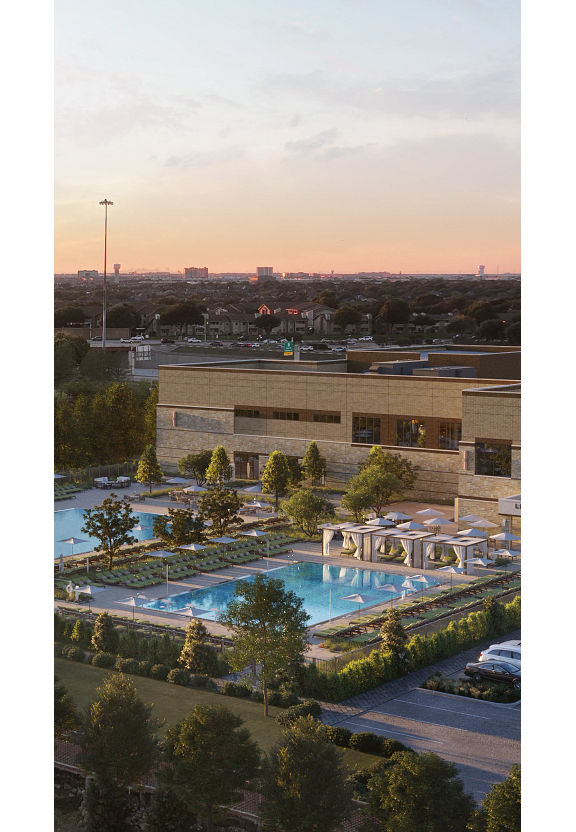 An aerial view of the exterior of Life Time Las Colinas at dusk