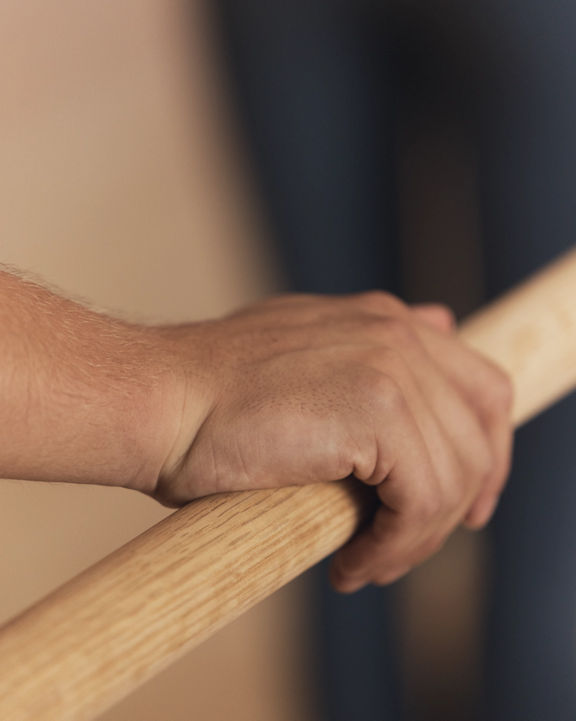 Life barre class participant's hand on barre for support at Life Time