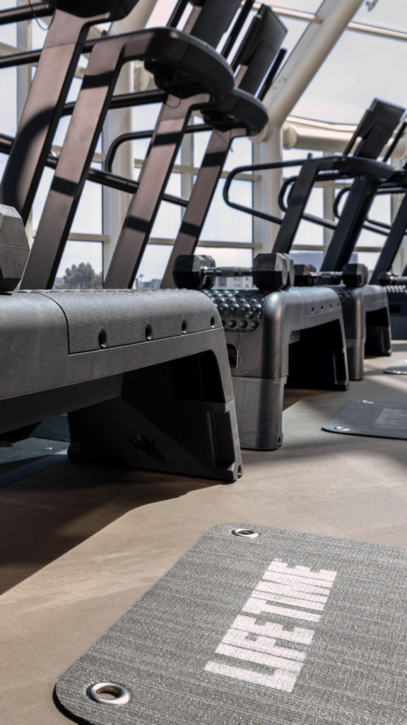 Treadmills and steps on the fitness floor at Life Time