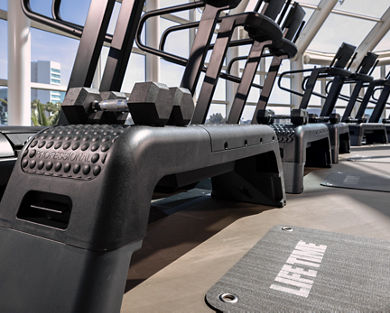 Treadmills and steps on the fitness floor at Life Time