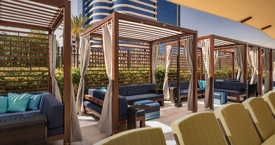 Cabanas and lounge chairs on a rooftop pool deck