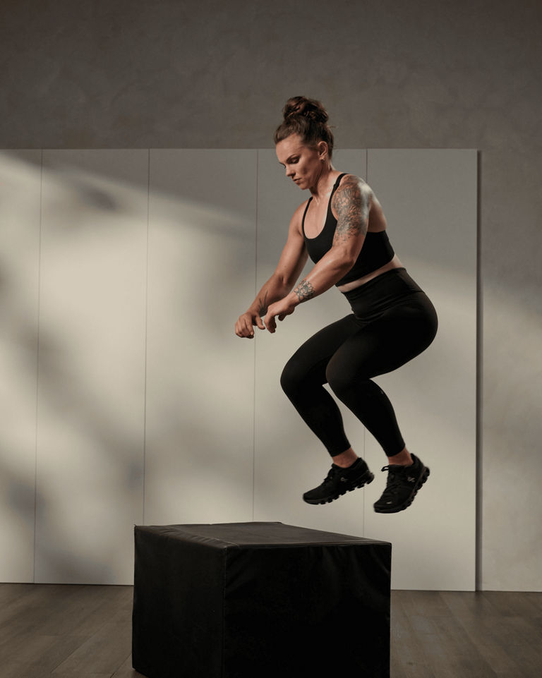 A woman performing a box jump