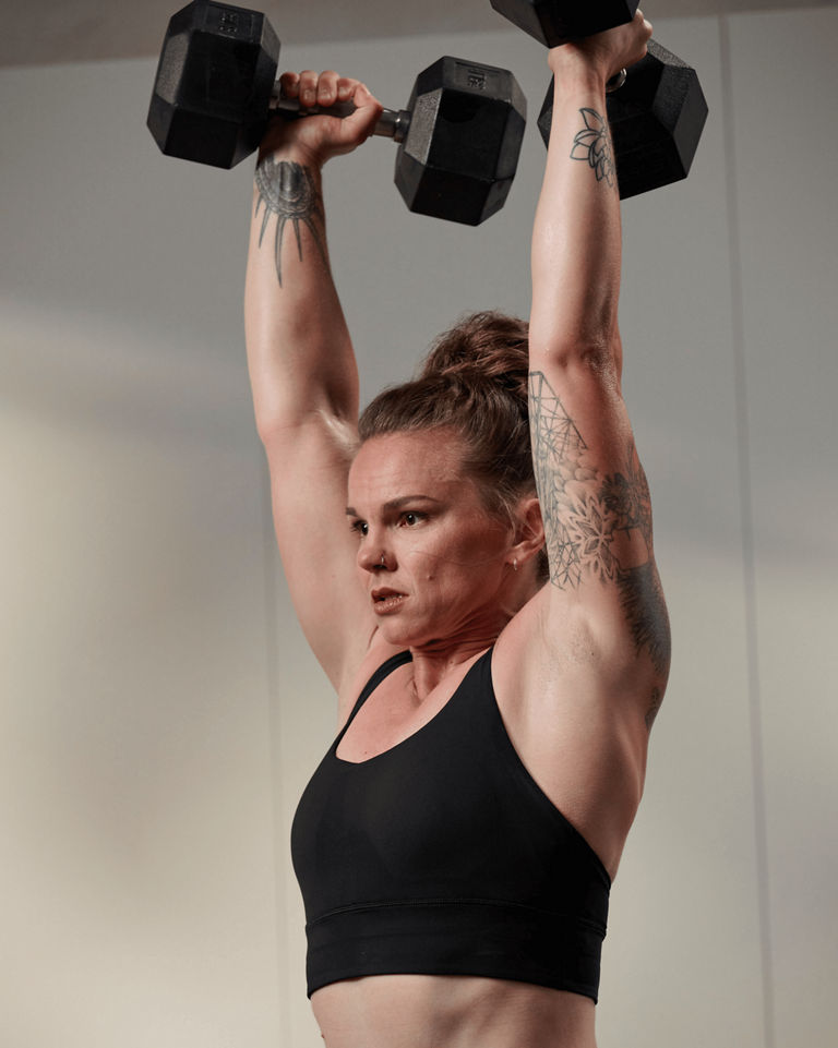 a woman lifting dumbells
