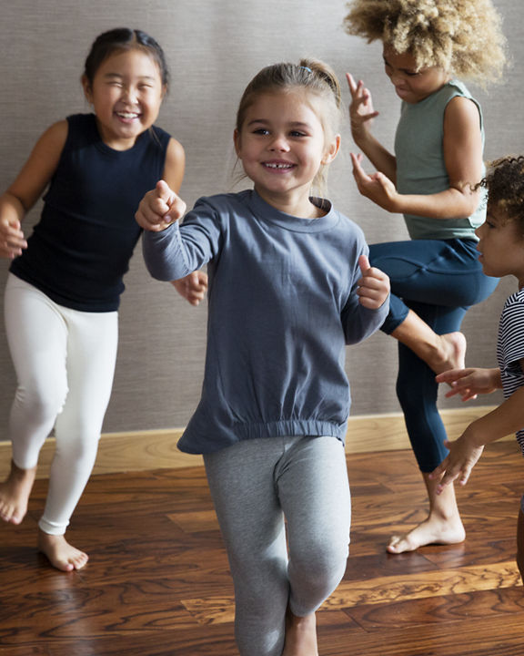 Young children smiling and dancing during a Life Time Kids Academy dance class