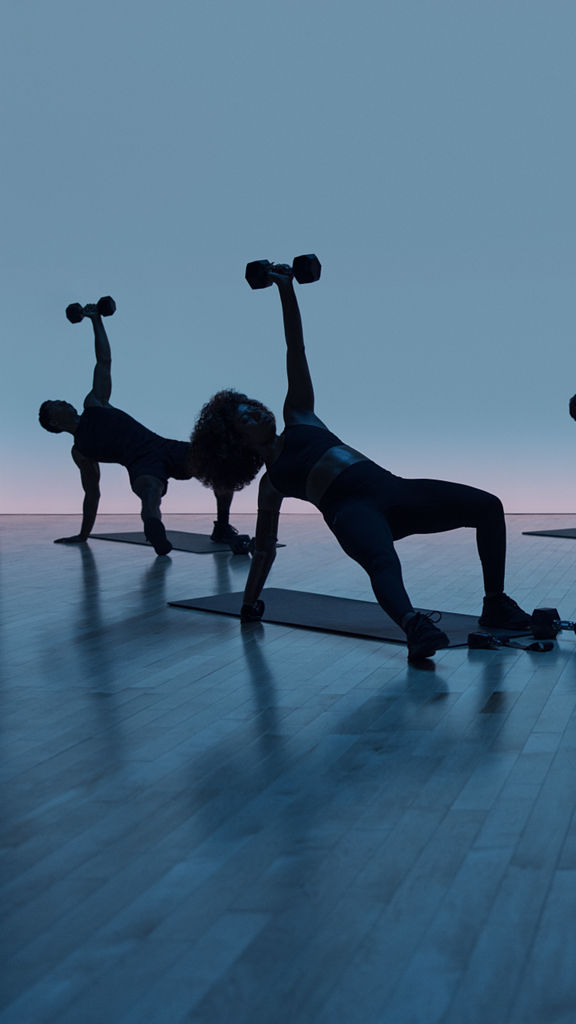 Maxout strength class featuring a group of people in silhouette working out on the floor with barbells