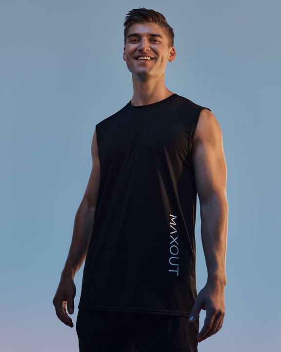 A person standing and smiling in a maxout strength class at Life Time