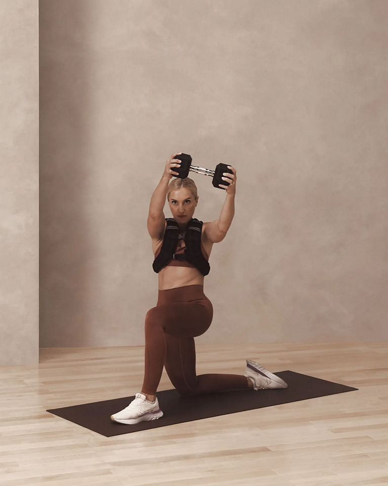 a woman in a knelling chop pose