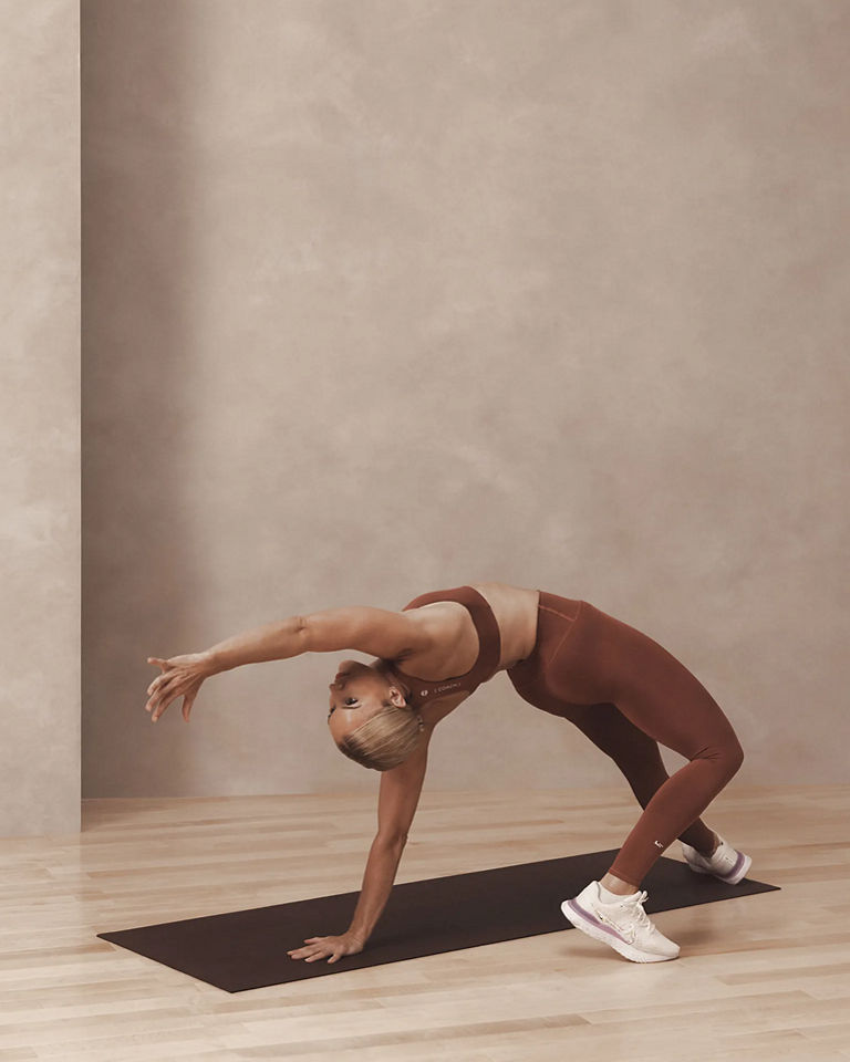 a woman in a scorpion roll pose