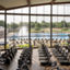 Fitness floor at Life Time McKinney at Craig Ranch looking out at the outdoor pool