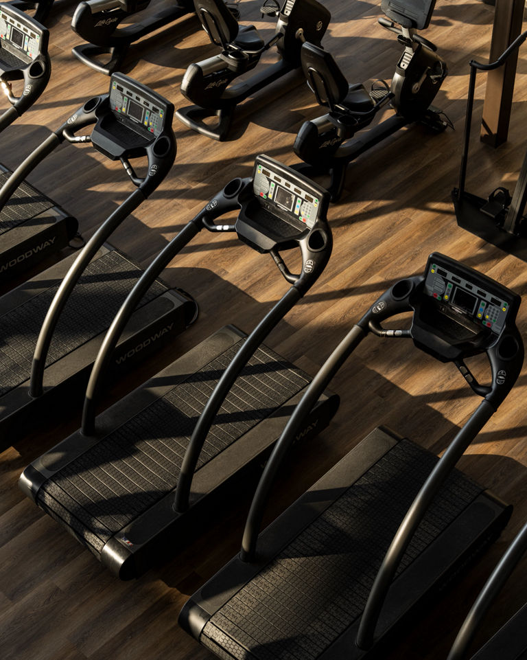 Overhead view treadmills lined up on a fitness floor at Life Time