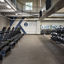 A row of treadmills, kettlebells, and medicine balls in a GTX training area