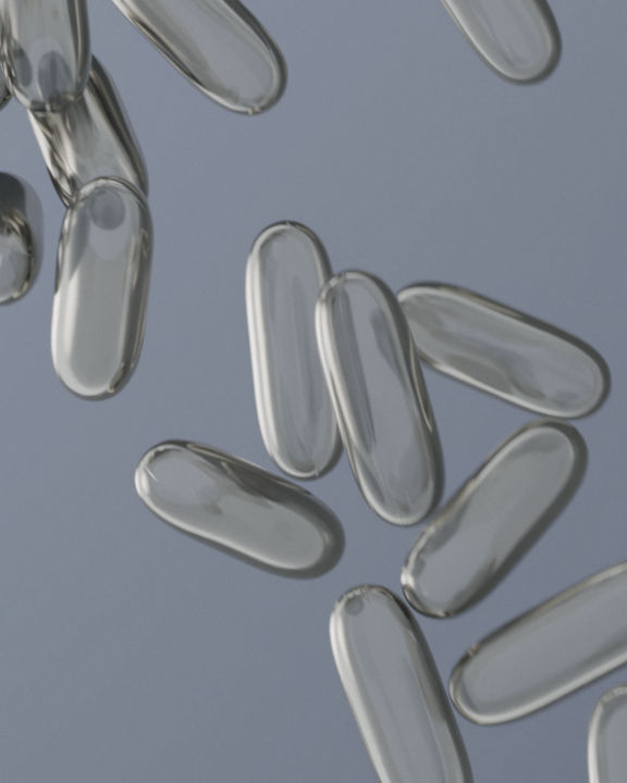 clear pill capsules on a gray background
