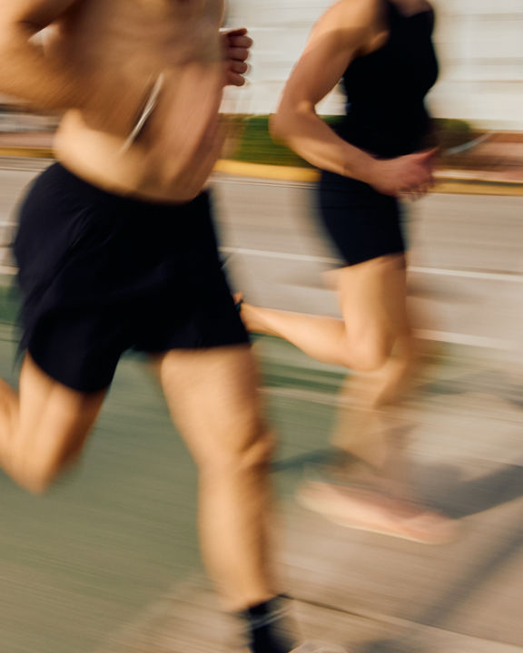 two people running next to each other at a marathon race