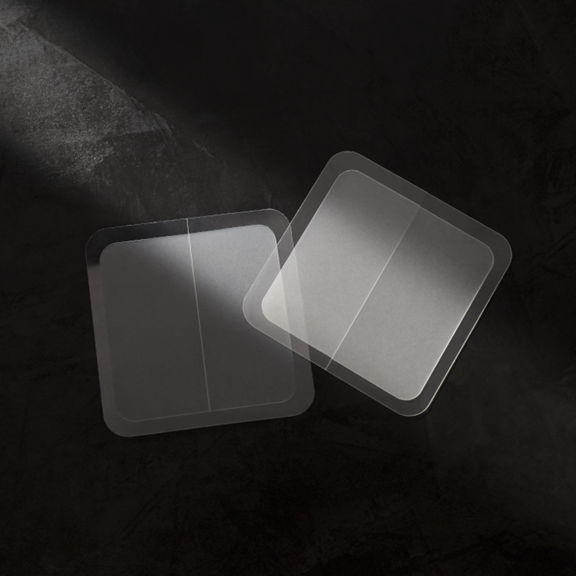 Two patches sitting on top of a dark gray background