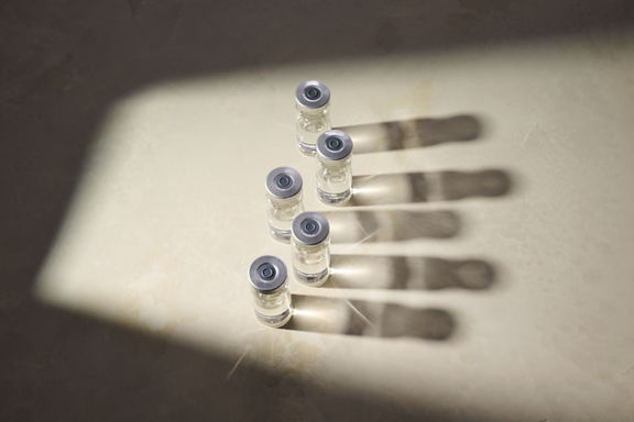 Several clear vials sitting on top of a cream-colored countertop