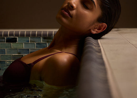 a woman relaxing in a whirlpool at Life Time