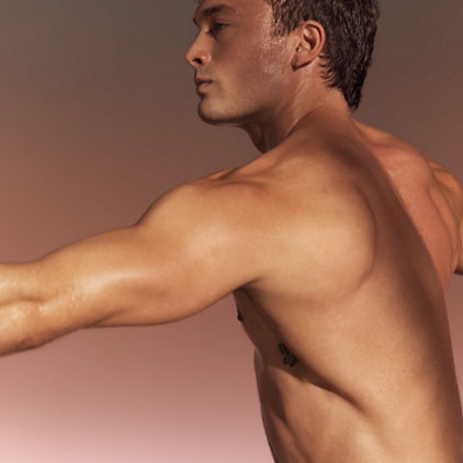 Yogi with well-muscled arms in warrior sculpt class at Life Time
