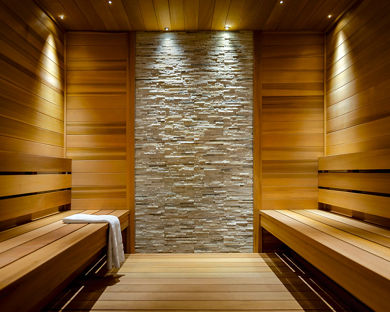 Brightly lit wooden and tiled sauna at Life Time